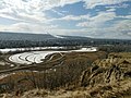 Escarpment view of Dale Hodges Park, a section of Bowmont Park Calgary with Calgary Olympic Park.jpg