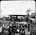 Fairground ride and crowd (6537939543).jpg