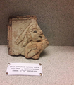 A terracotta tile of Bhismaknagar depicting a person with a hand-cannon.png